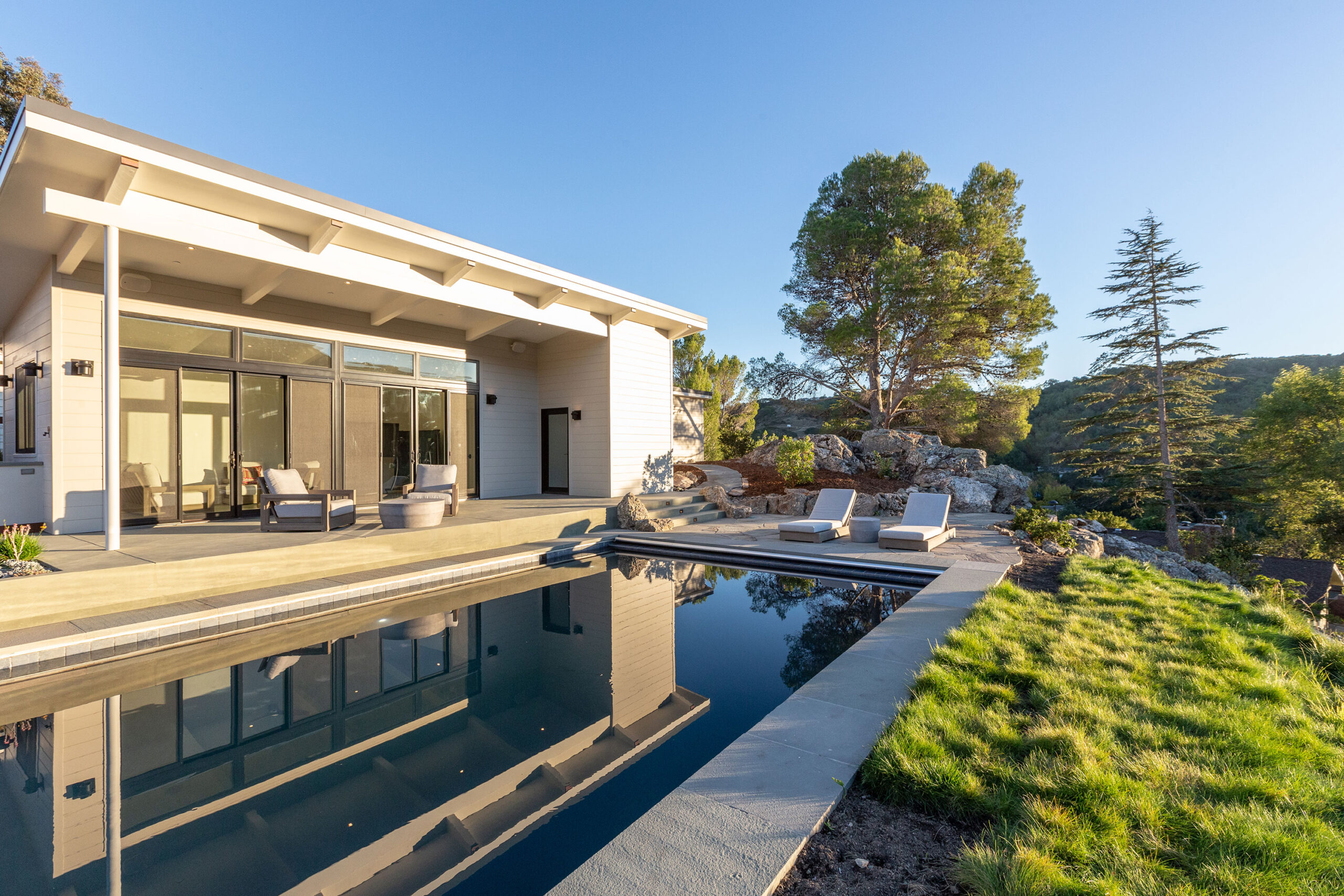 garden rock daylight shot of pool house and pool